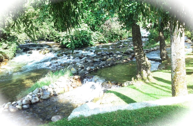 A mountain house nestling on the banks of a river *