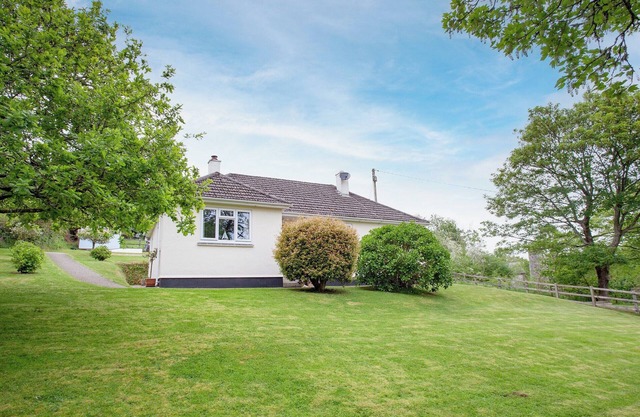 A spacious bungalow for four overlooking a wooded valley with its own garden.