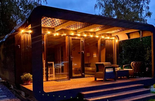 A tiny house with a garden and a hot tube