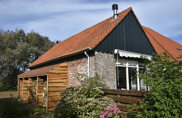 Beautiful authentic cottage in the middle of nature on farmyard with beautiful orchard