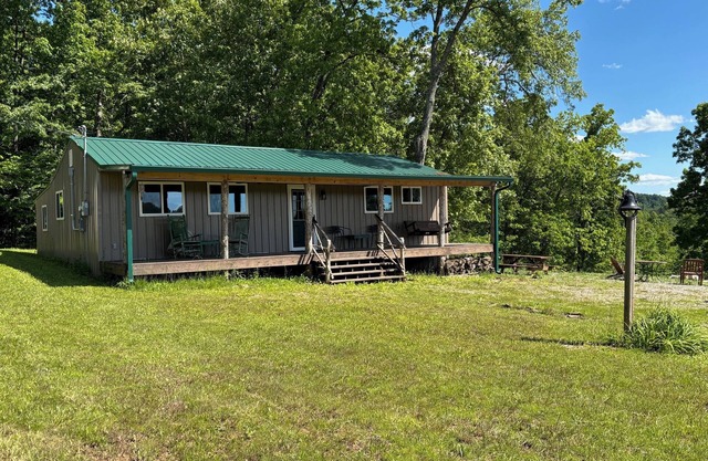 Beautiful Cabin Nestled in a Peaceful Wooded Setting with a Scenic Pond.