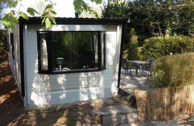 Beautiful chalet for rent overlooking ornamental pond against forest + parking lot