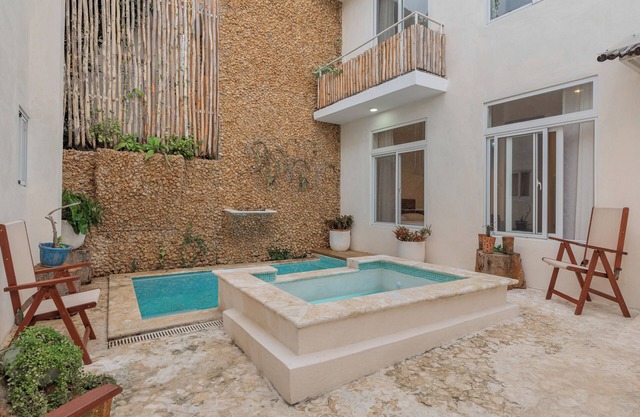 Bohechio studio with private balcony, pool views, ensuite bath, and kitchen.