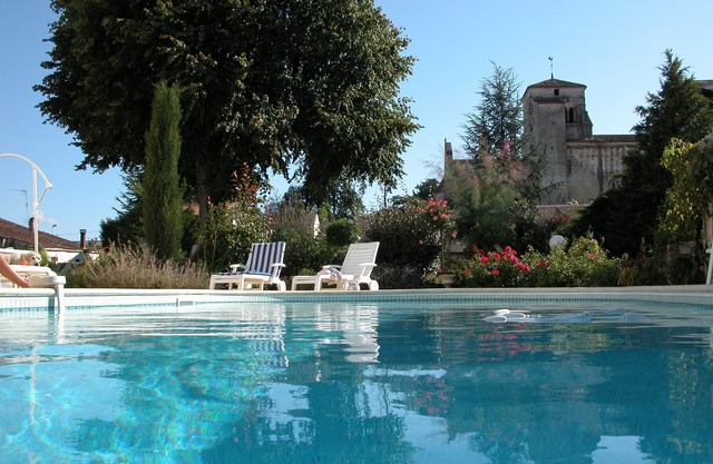 Character house, air-conditioned, heated pool, fenced garden with trees.