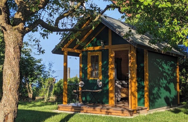 Cozy garden shed to linger in with garage