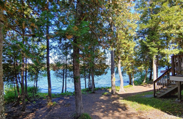 Cozy lakefront home w/ a firepit, outdoor shower, & private beach!