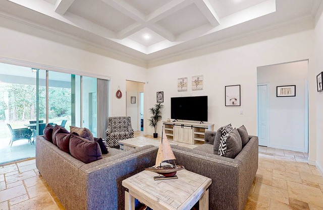 Dog-friendly home with Tesla EV charger, yard, patio, grill, AC, & W/D