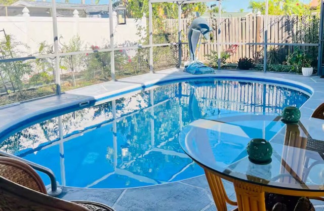 Dog-Friendly Tropical Getaway with a Covered Pool -Nearby Beaches!