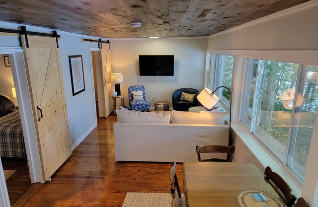 Enjoy Lake life in this renovated Camp, 50 ft from water. Private dock, beach.