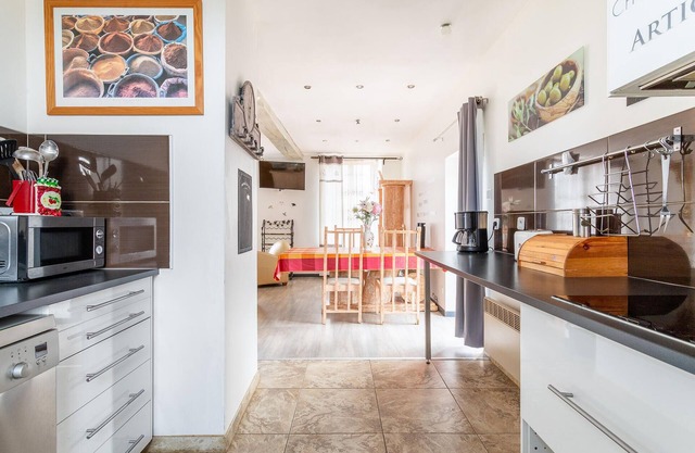 Enjoy this cozy and pretty vacation home by a stream in green surroundings.