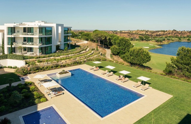 Escape to luxury in the Monte Rei 3-Bedroom Penthouse Apartment with a communal heated pool and stunning views