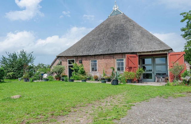 Farmhouse by Lauwers River with Rowing Boat