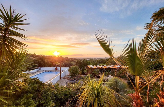 Hidden villa with pool and sea views, located in a green area.