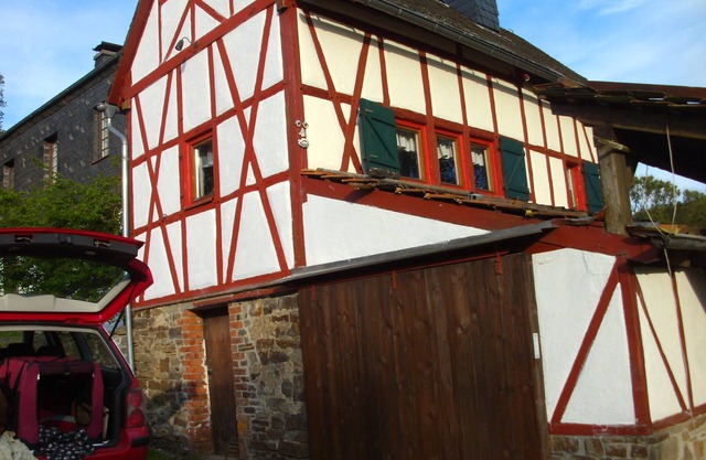 historic half-timbered house on the edge of a forest in a secluded location