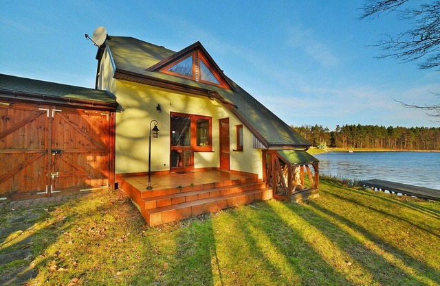 Holiday Home by Lake Rosnowskie with Boat