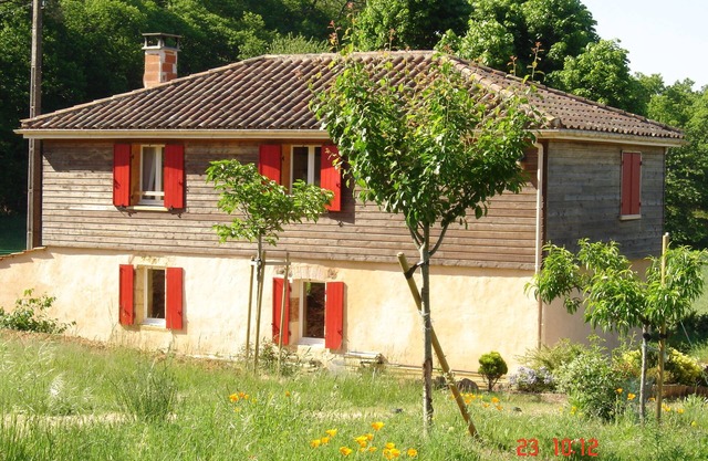 House in the countryside, with large expanses of woods and fields.