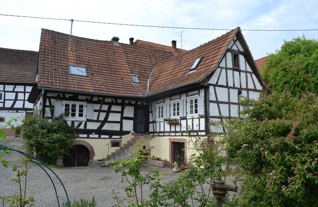 Idyllic half-timbered house with a large garden and playground and orchard