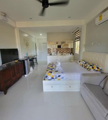 INATO SUITES Rm 1 1 queen bed and a pullout sofa bed