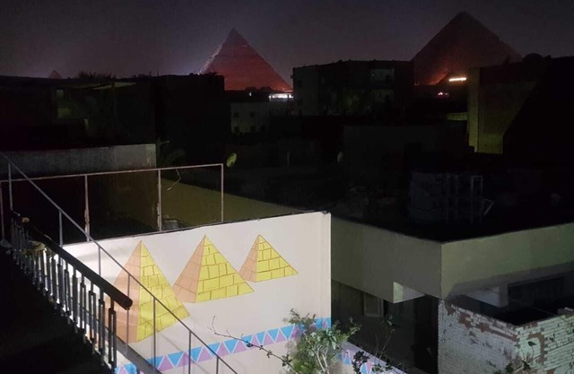 It's a house .it has aquit roof with a view of pyramids