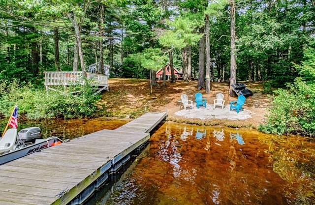 Lakefront dog-friendly home with dock, waterfront deck, wood fireplace, & W/D
