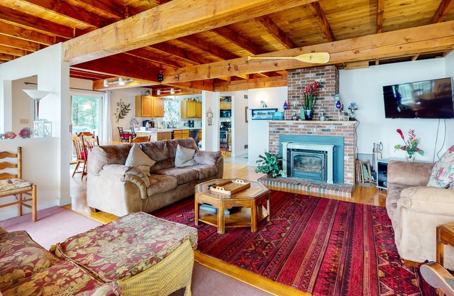 Lakefront dog-friendly cape-style home with row boat, water access & lake views