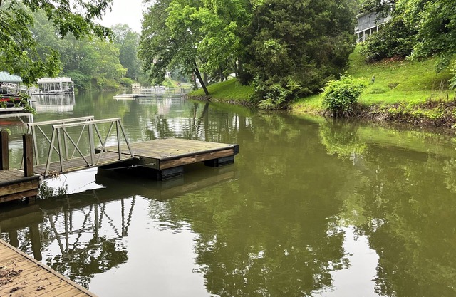Lakefront home with dock. Cozy 2 bed 2 bath and screened in porch.