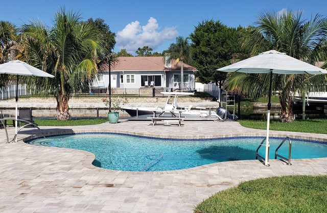 Luxury waterfront pool home with dock.
