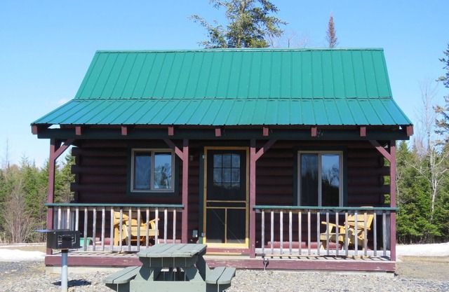 Modern log cabin with pond view available for rent in middle Maine.