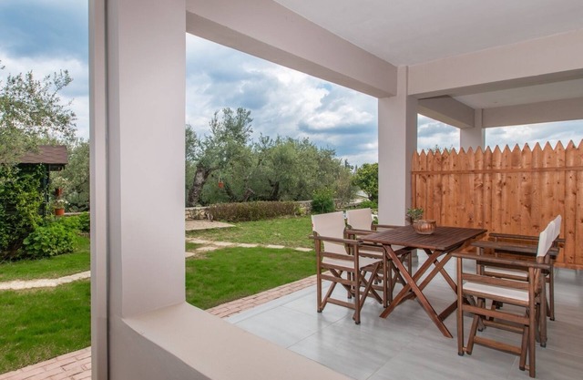Nestled on the ground floor with direct garden access amidst olive trees