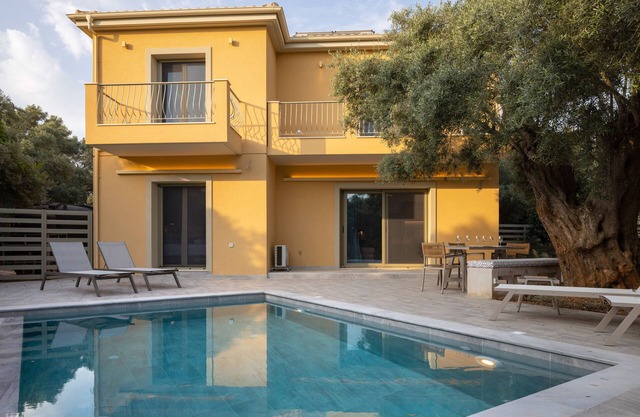 New 3-bedroom modern villa with private pool, surrounded by olive trees.
