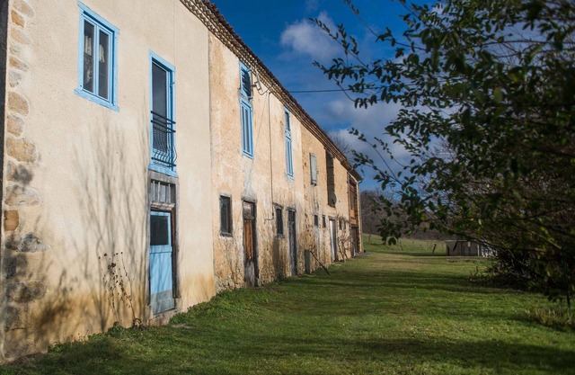 Old farmhouse in the middle of fields near a greenway