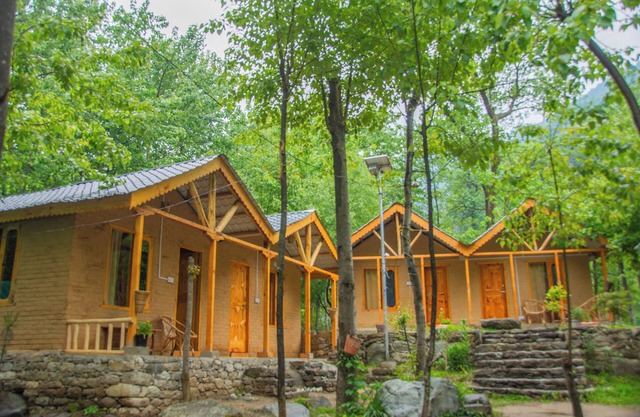 Riverside wooden cottages with a great valley-scape