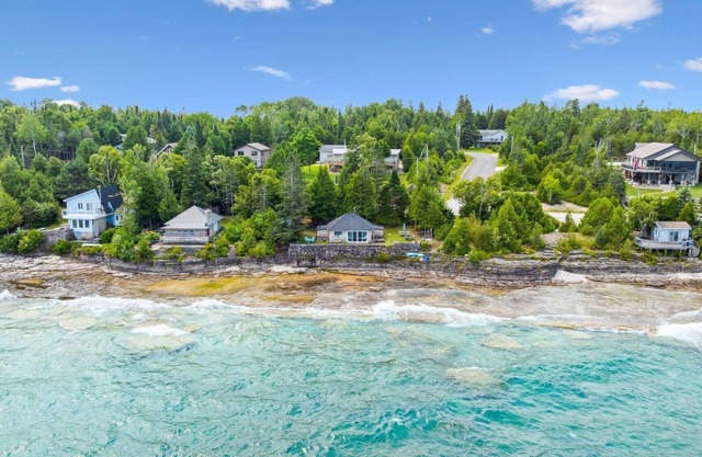 Seafari is a charming stone cottage on Georgian Bay with stunning bluff views, a flat rock shoreline, and a cozy bunkie. Perfect for relaxing, swimming, and exploring.