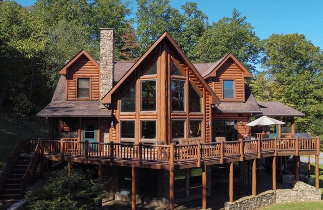 Secluded 4 bedroom log style home with screened porches, deck and fishing pond.