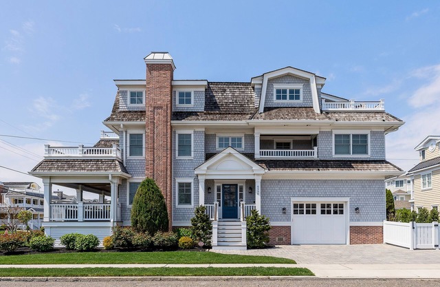 Spacious deck has ocean views as home is across the street from the beachblock.