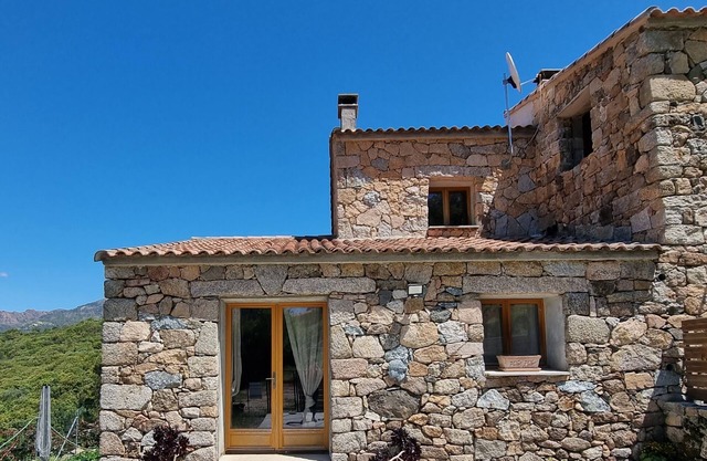 Stone house located between sea and mountains