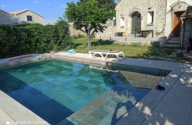Stone house renovated in a contemporary style with garden and swimming pool.