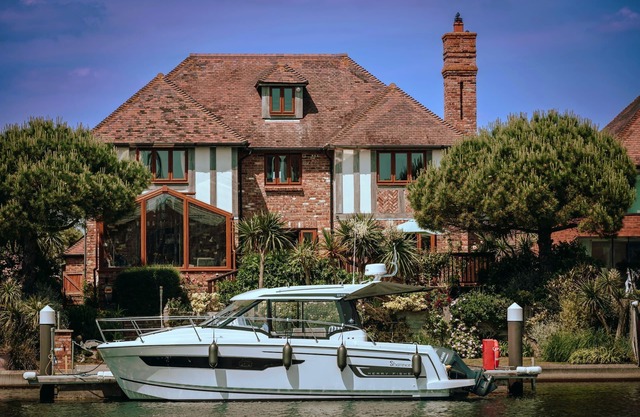 Stunning waterside six-bed house with water views, gardens and private jetty