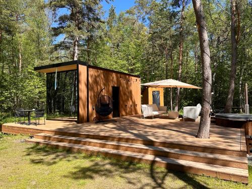 Telise TinyOne is a modern forest cabin with a cozy hot tub
