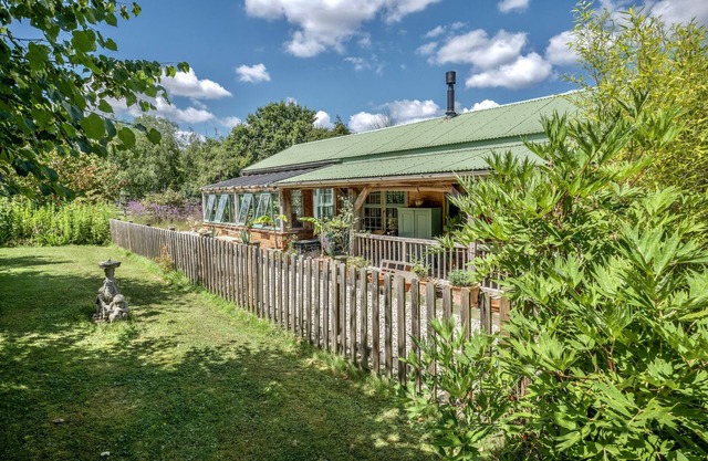 The Garden Room. Timber framed, light and airy accommodation with veranda.