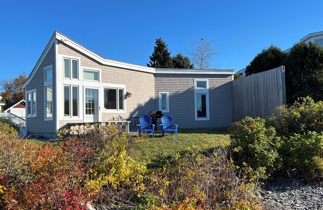 This sweet cottage offers a shared pebbly beachfront and gorgeous sunset views