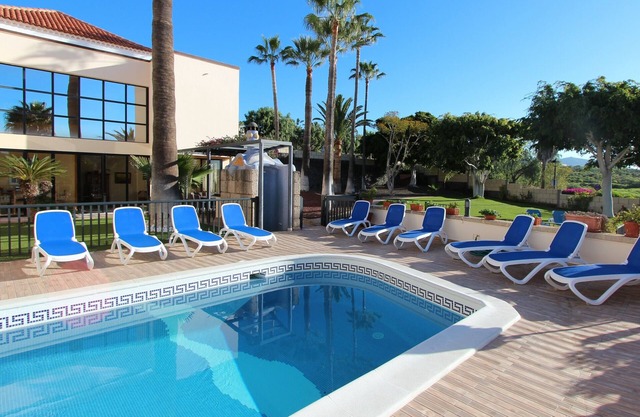 Villa with pool for exclusive group holiday under palm trees