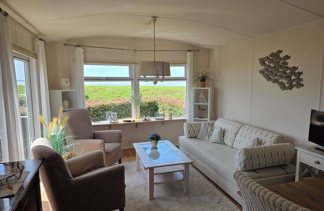 Watch the sun sink into the sea from your living room at Chalet WadRust