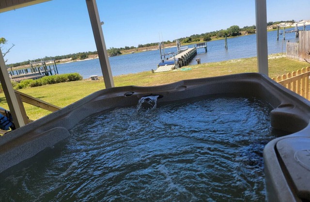 Waterfront home with Private Dock, 3 miles to Beach, Hot tub, kayaks, and swimming area, large fenced backyard, pet friendly