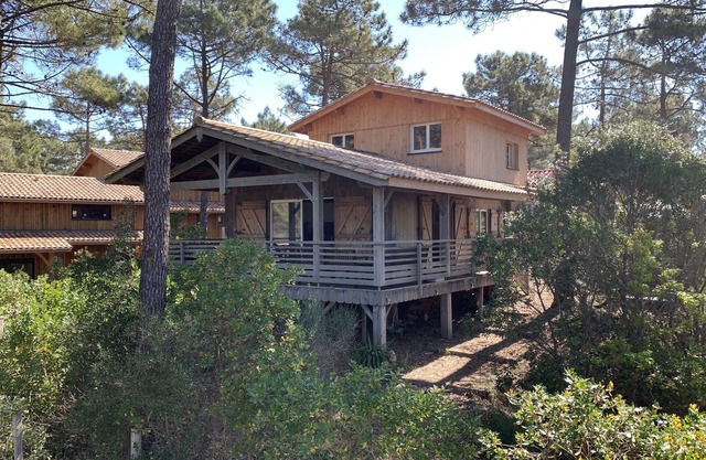 Wooden house close to the ocean in a gated community.