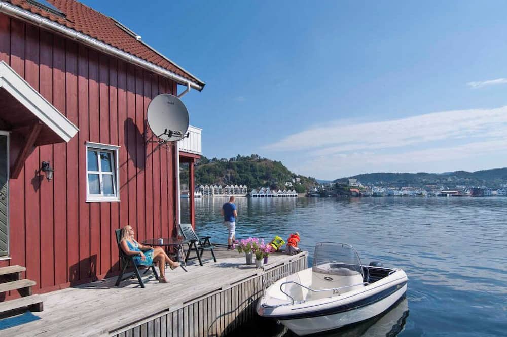 Flekkefjord Apartment | Holiday apartment "Fagerstrand 1", in Flekkefjord, southern Norway, in a beautiful location directly on the water, 4-6 persons, open living-dining area, 2 bedrooms, 1 loft with double mattress, 1 bathroom, Internet, own small veranda with access t...