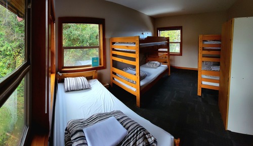 Private room with 5 single beds and shared bathrooms