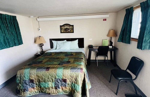 Onalaska House | Overlooking Lake Onalaska -- Queen bed + bathroom in nostalgic motel