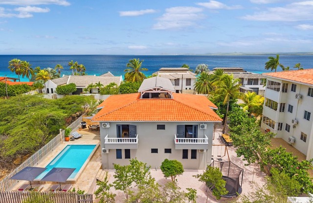 Spacious 5-bedroom villa on Bonaire with private pool, ocean view rooftop terrace, tropical garden, near top kitesurfing & diving spots. Sleeps 10 persons.